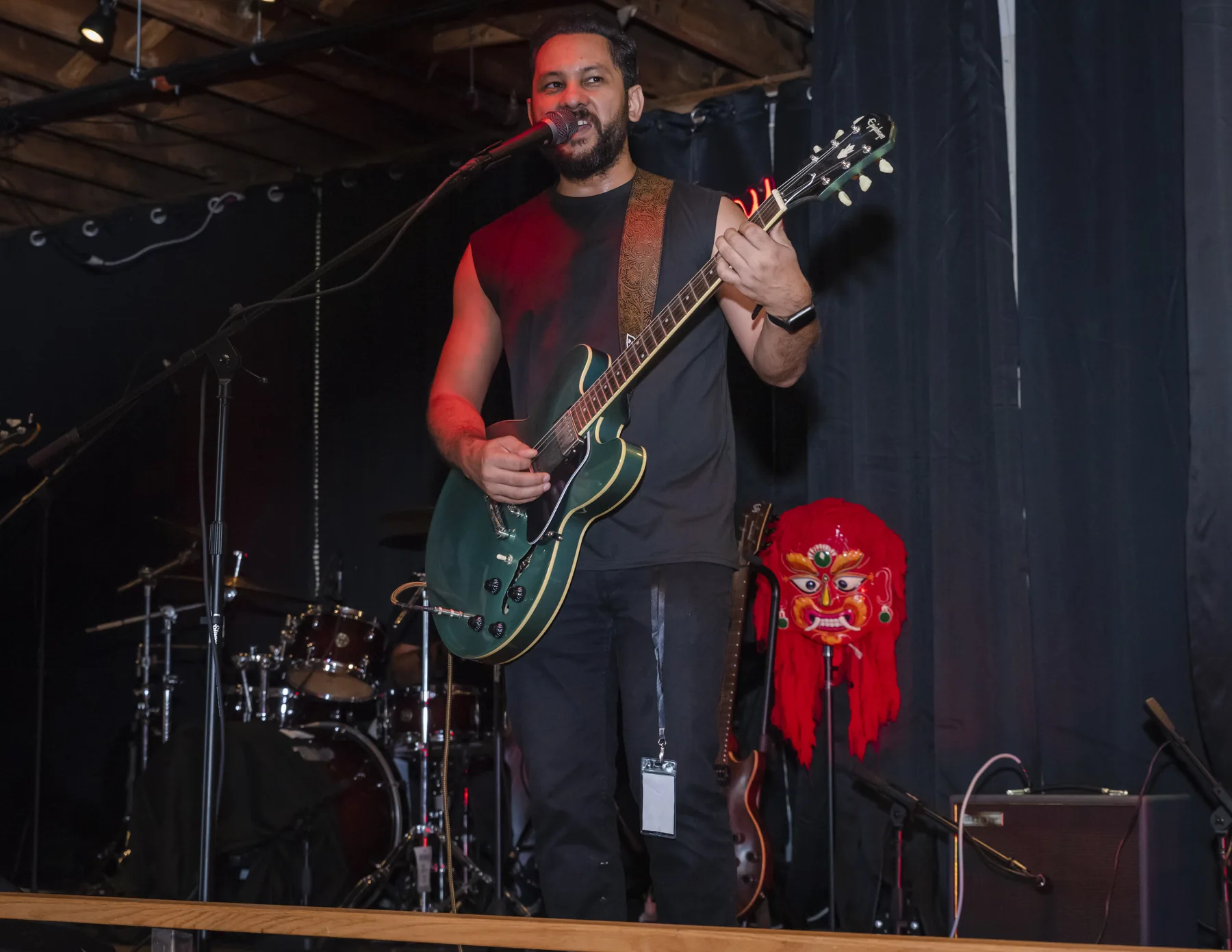 Saurav MP singing and playing electric guitar on stage