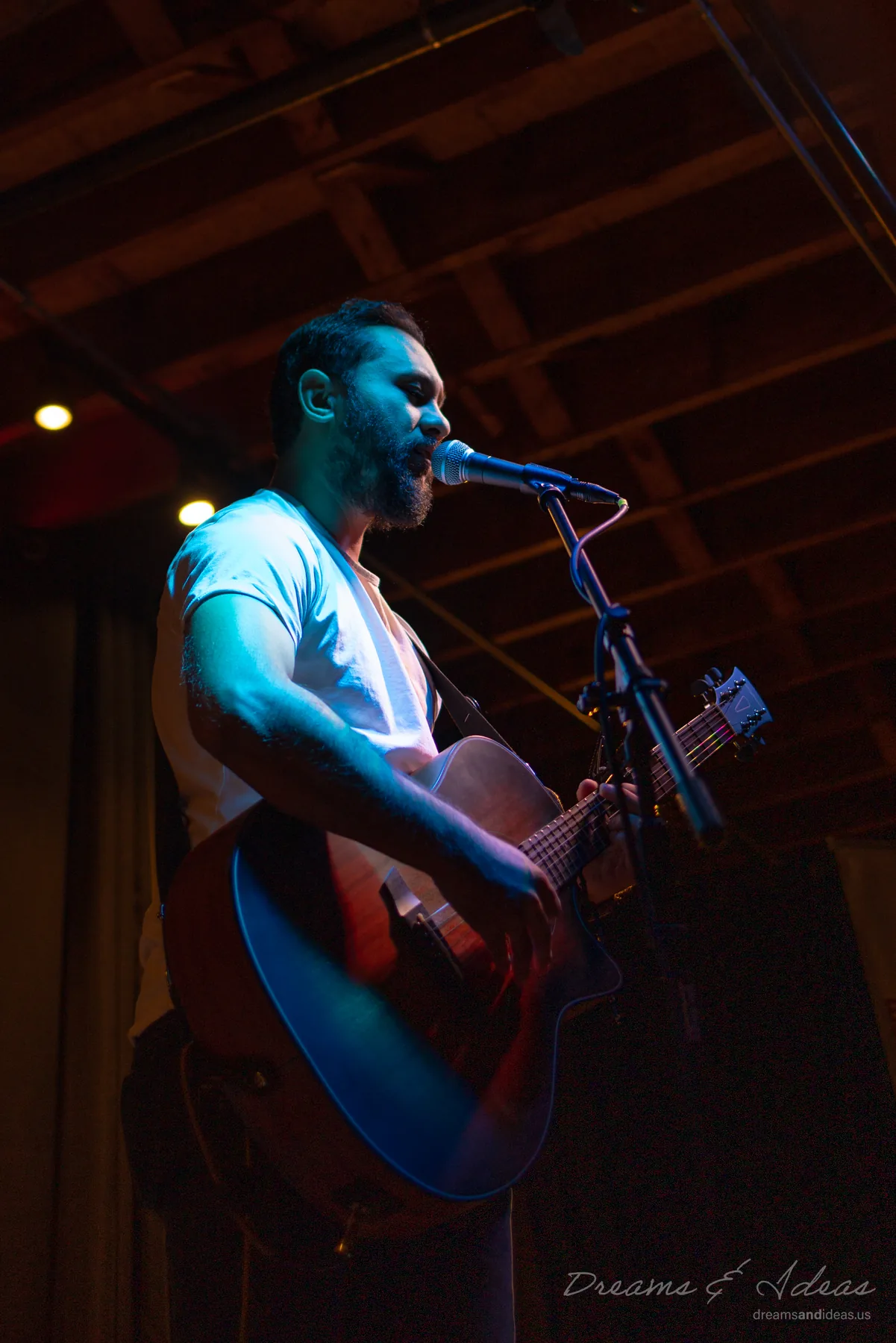 Saurav MP singing and playing guitar on stage