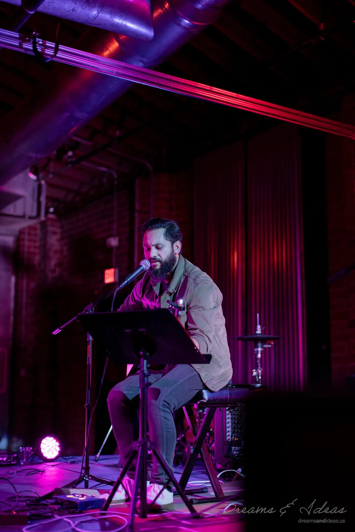 Saurav MP performing under purple stage lights