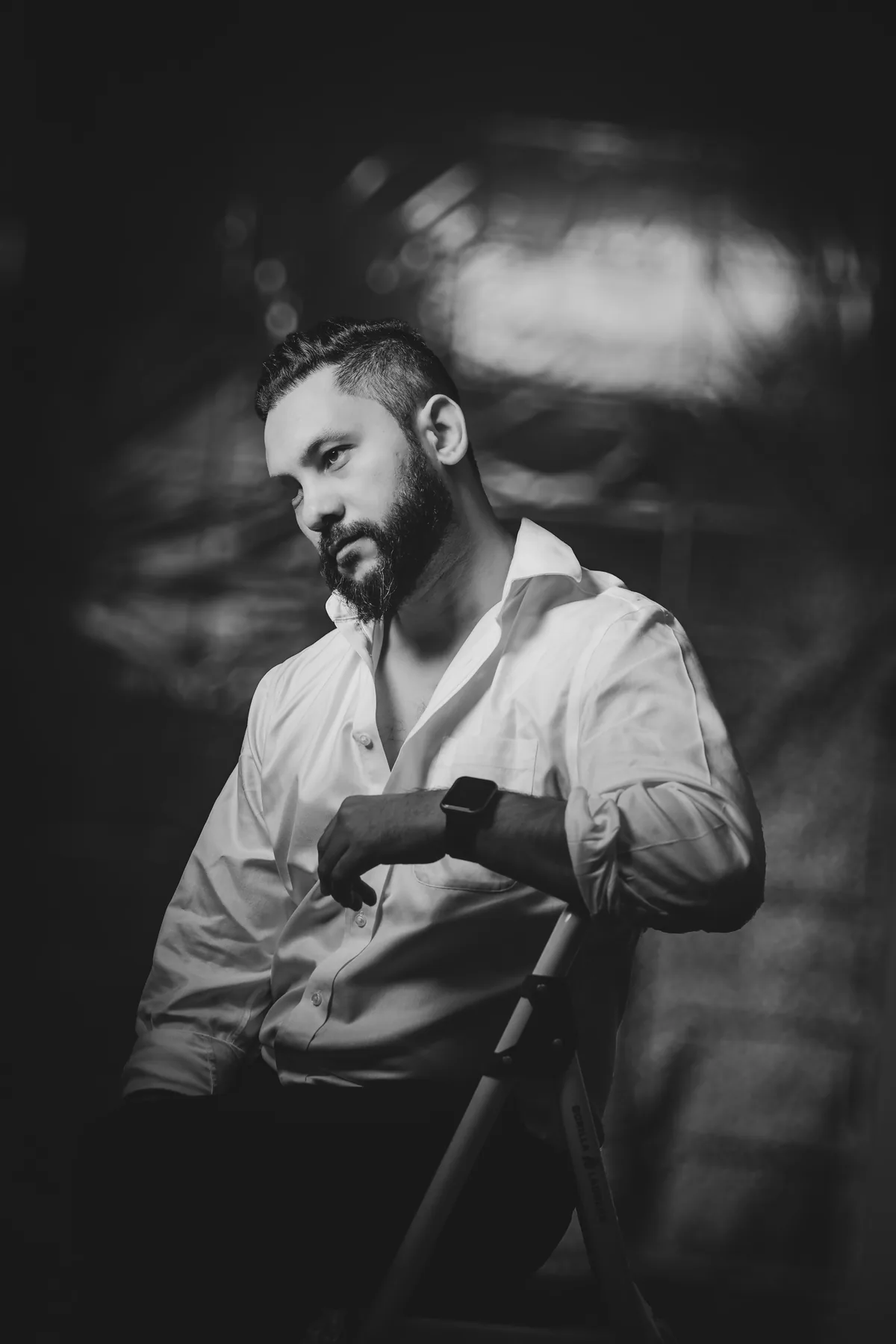 Black and white portrait of Saurav MP playing guitar
