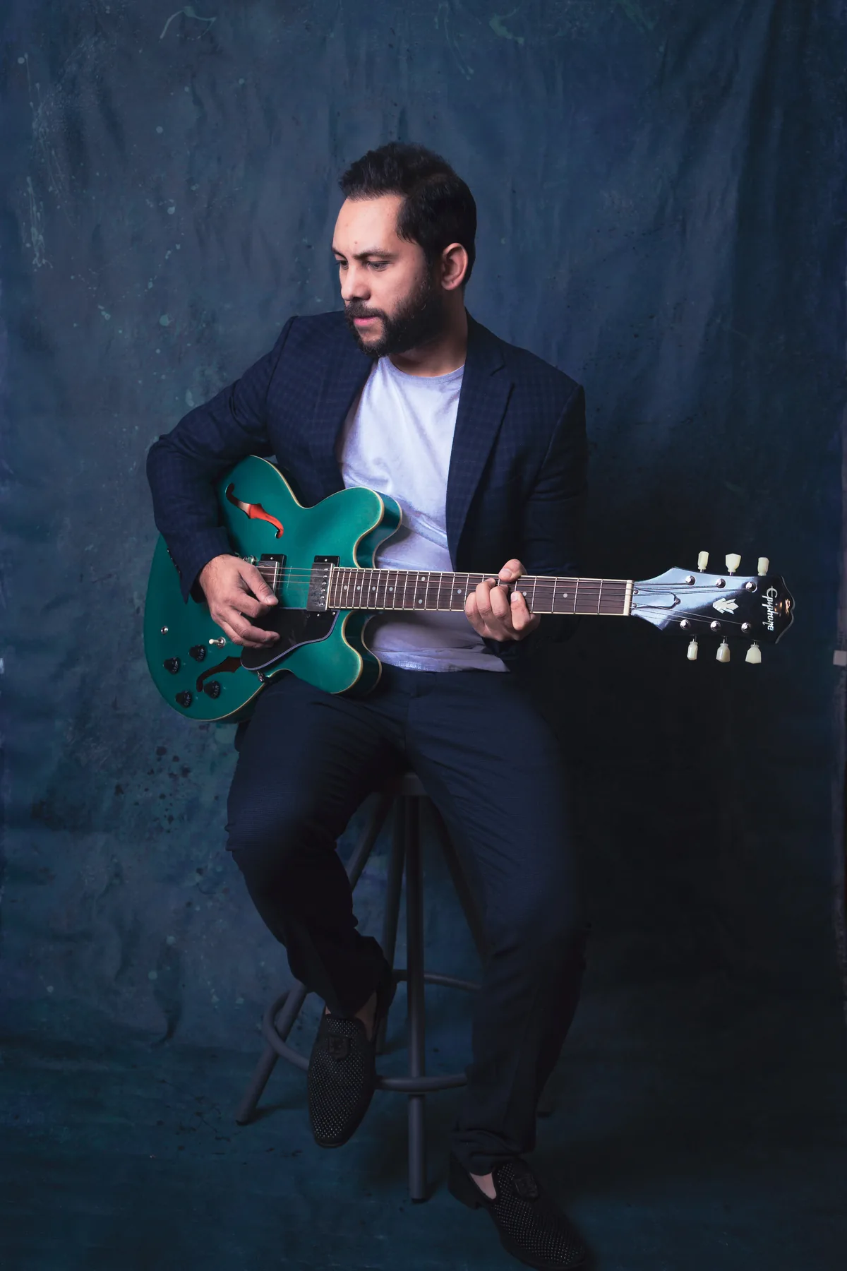Studio portrait of Saurav MP with a guitar